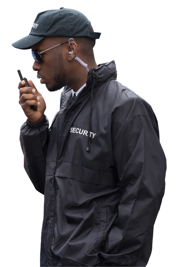 A man in black jacket holding a walkie talkie.